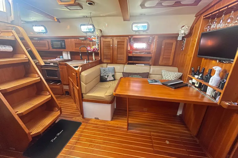 Slide: The Image of Luxurious 2008 Caliber 47 LRC yacht interior with wood finish, kitchen, and seating area. - 79
