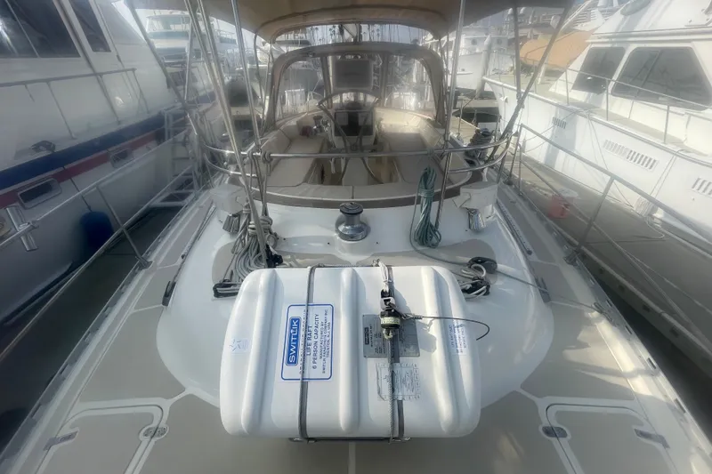 Slide: The Image of 2008 Caliber center cockpit cutter sailboat docked at marina, featuring sleek design and rigging. - 8