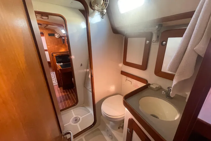 Slide: The Image of 2008 Caliber 47 LRC yacht bathroom with sink, toilet, and wooden accents. - 80