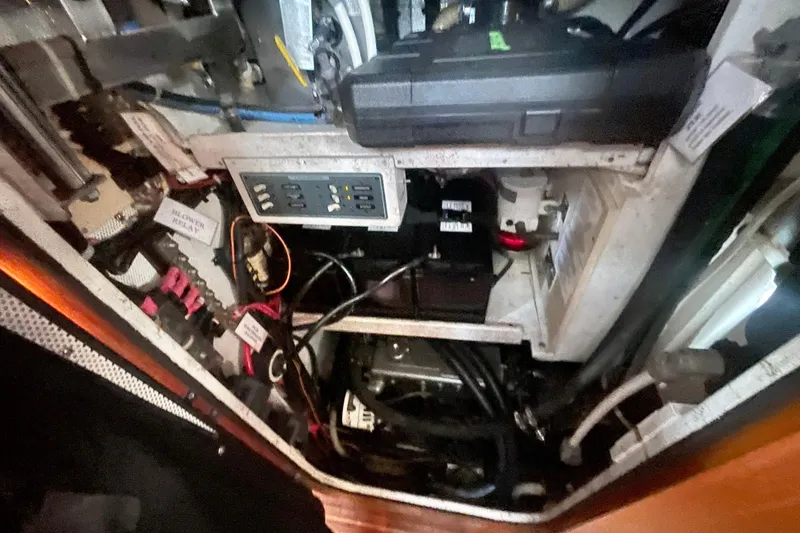 Slide: The Image of Engine compartment of a 2008 Caliber 47 LRC yacht, showcasing wiring and components. - 82