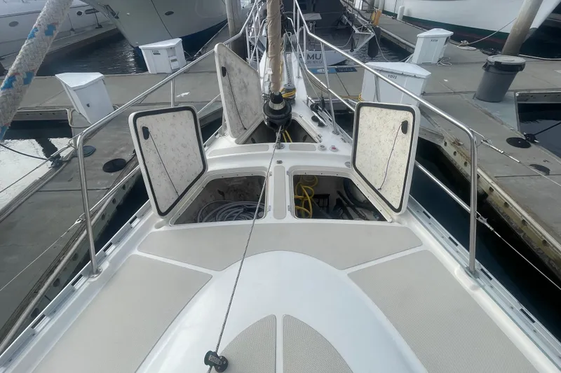 Slide: The Image of 2008 Caliber center cockpit cutter docked between boats in a marina. - 9