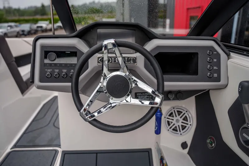 Slide: The Image of 2026 Cobalt CS22 boat dashboard with modern steering wheel and control panel. - 21