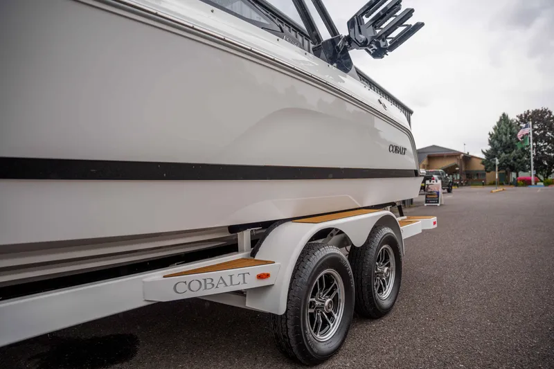 Slide: The Image of 2026 Cobalt CS22 boat on trailer, parked outdoors, showcasing sleek design. - 24