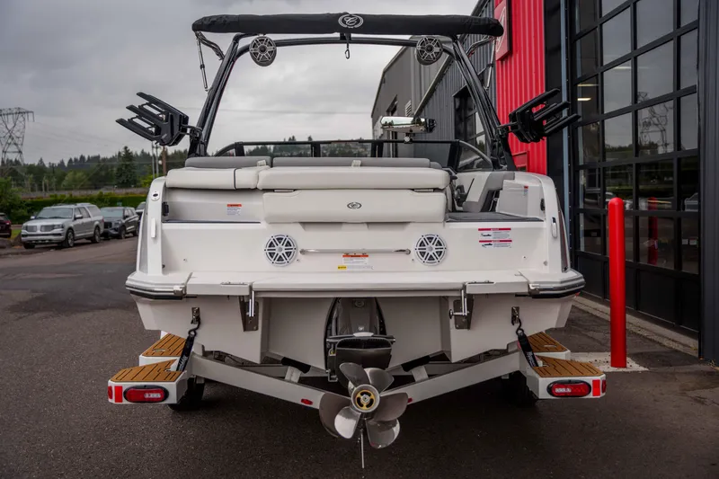 Slide: The Image of 2026 Cobalt CS22 boat rear view, parked near a modern building. - 4