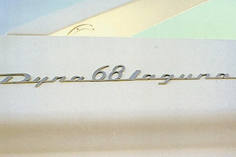 Slide: The Image of Dyna Laguna 68 emblem on a vintage vehicle, showcasing classic design. - 15