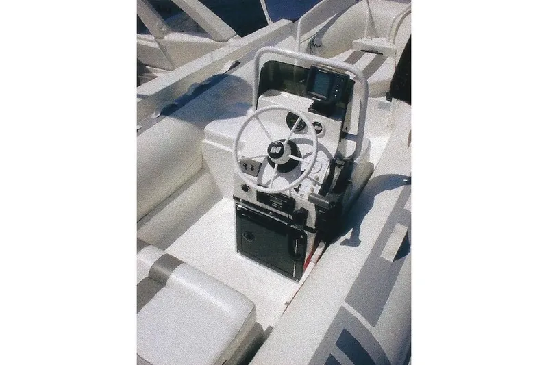 Slide: The Image of Interior of a Dyna Laguna boat featuring a steering wheel and control panel. - 18