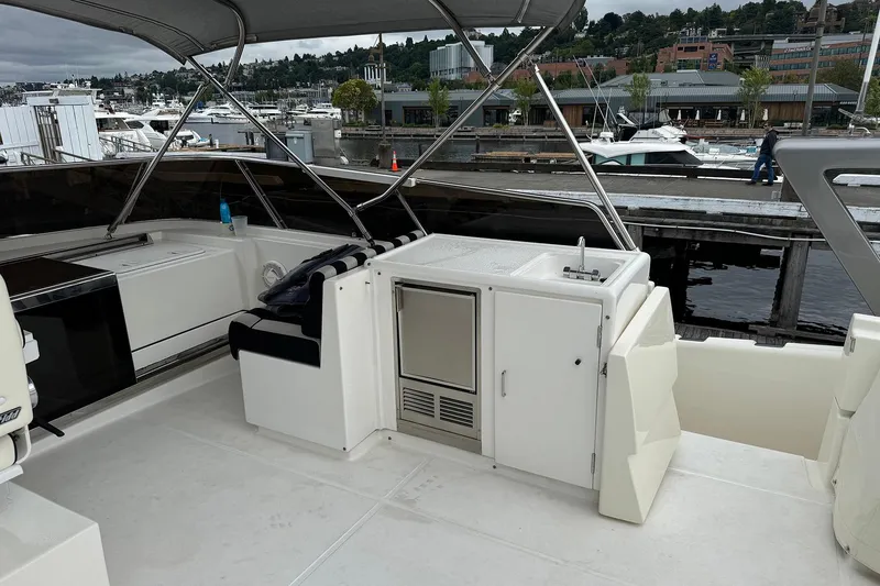 Slide: The Image of Dyna Laguna boat deck with seating and kitchenette, docked at marina. - 26