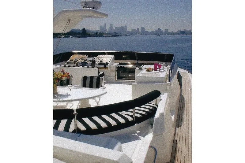 Slide: The Image of Luxurious Dyna Laguna yacht deck with city skyline view, featuring elegant seating and dining area. - 28