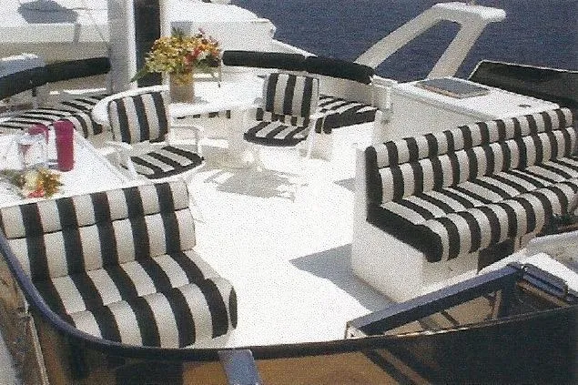 Slide: The Image of Luxurious Dyna Laguna yacht deck with striped seating and ocean view. - 29