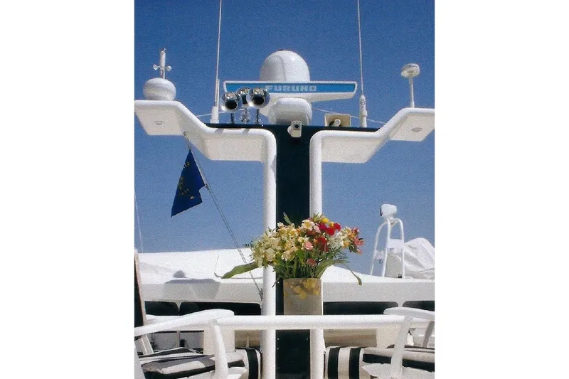 Slide: The Image of Luxurious Dyna Laguna yacht deck with flowers and radar equipment against clear blue sky. - 31