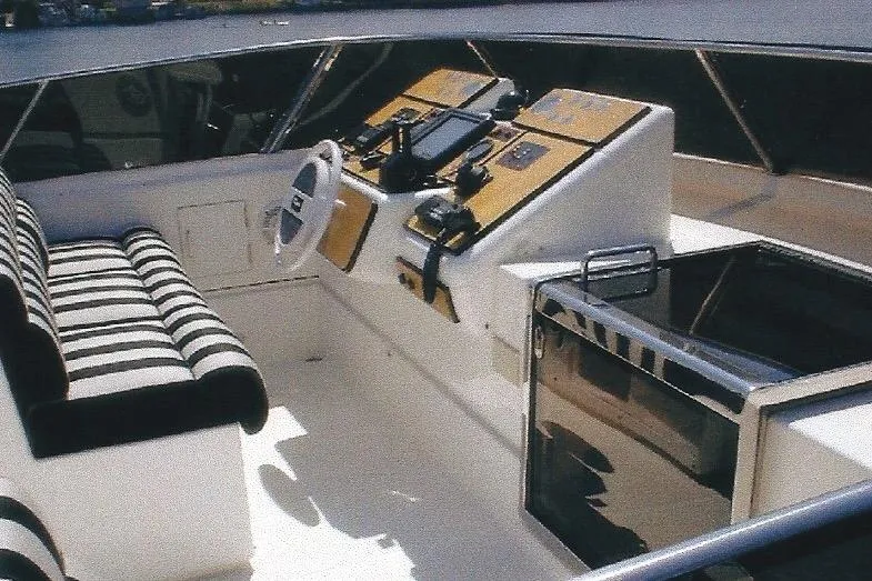 Slide: The Image of Cockpit of Dyna Laguna boat with striped seating and control panel. - 32