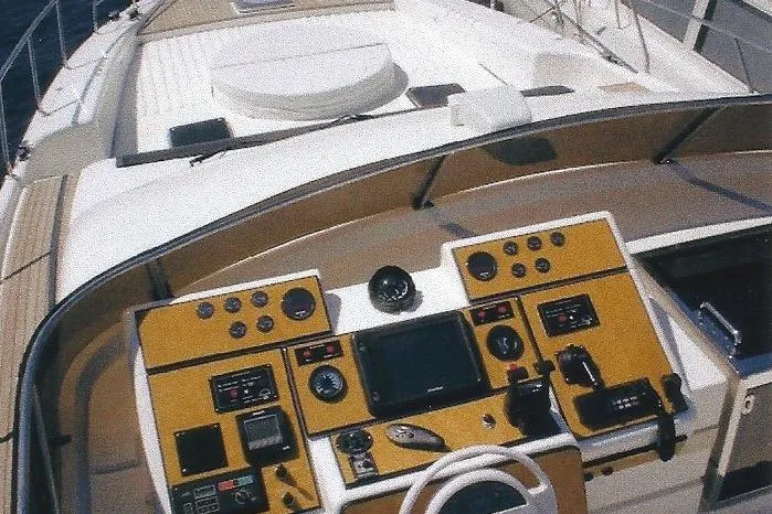 Slide: The Image of Cockpit of a Dyna Laguna yacht with advanced navigation controls and steering wheel. - 33