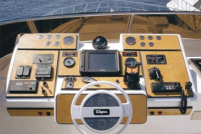 Slide: The Image of Cockpit of Dyna Laguna yacht with navigation controls and steering wheel. - 34