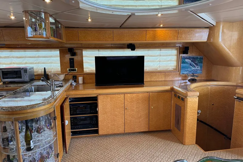 Slide: The Image of Luxurious Dyna Laguna yacht interior with TV, bar, and modern kitchen amenities. - 35