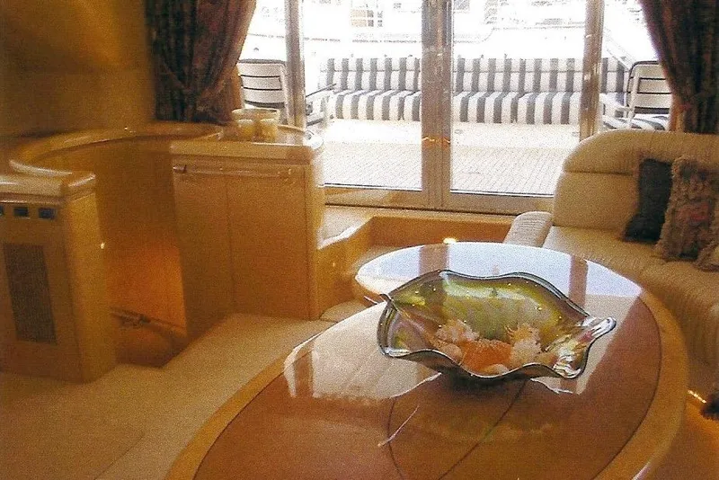 Slide: The Image of Luxurious yacht interior with elegant decor, featuring a glass centerpiece on a polished table. - 37