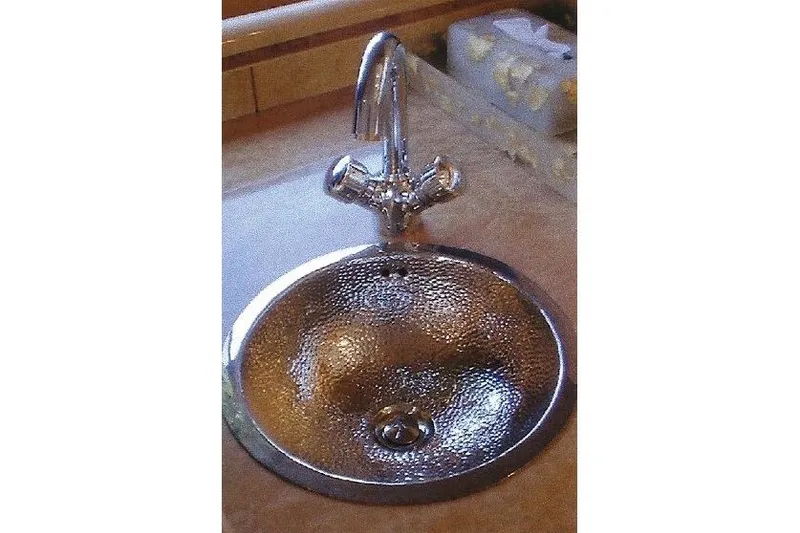 Slide: The Image of Hammered metal sink with chrome faucet on a countertop, Dyna Laguna model. - 41