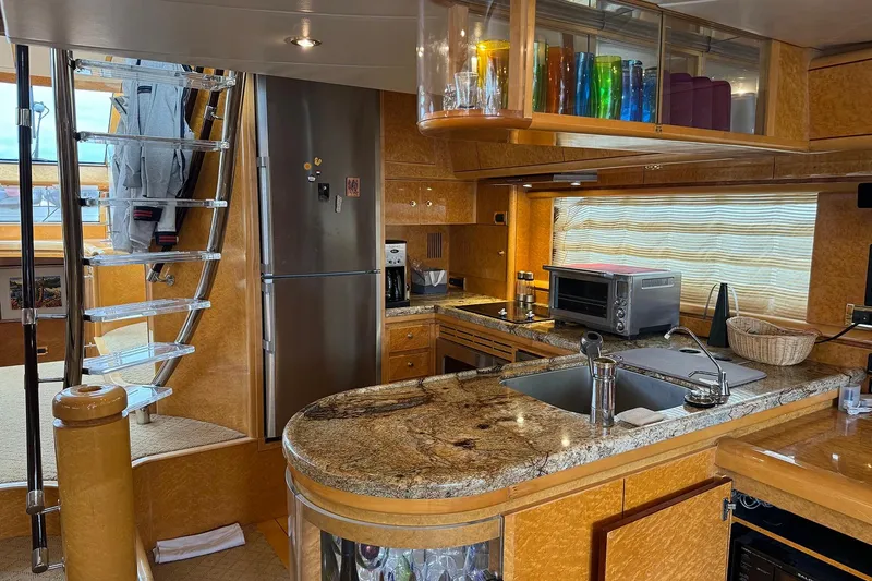 Slide: The Image of Luxurious Dyna Laguna yacht kitchen with granite countertops, stainless steel appliances, and modern design. - 43