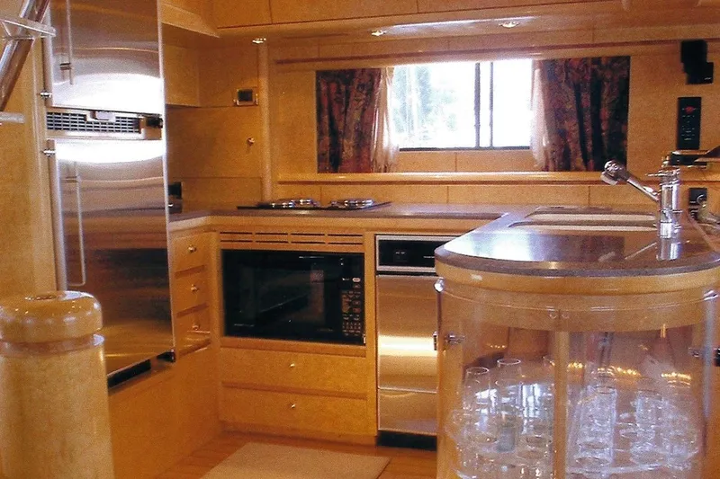 Slide: The Image of Luxurious Dyna Laguna yacht kitchen with modern appliances and elegant wood finishes. - 45