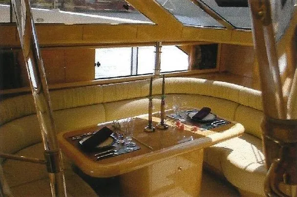 Slide: The Image of Luxurious Dyna Laguna yacht interior with elegant dining setup and plush seating. - 47