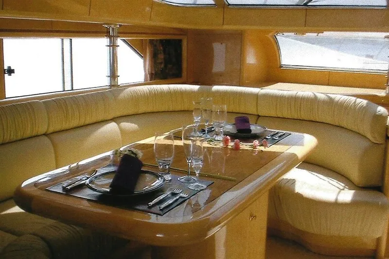 Slide: The Image of Luxurious Dyna Laguna yacht interior with elegant dining setup and plush seating. - 48