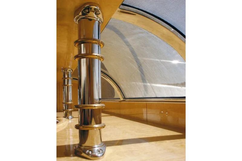 Slide: The Image of Polished metal column inside Dyna Laguna, with curved window and wooden interior. - 49