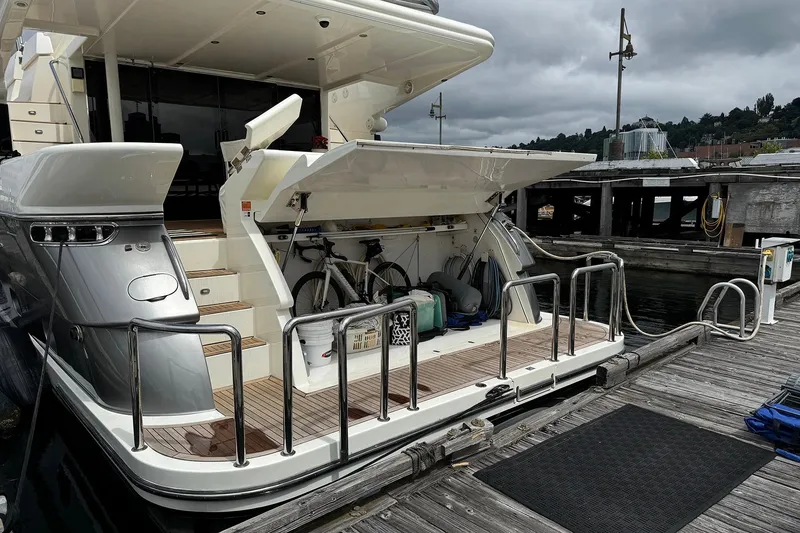 Slide: The Image of Luxury yacht Dyna Laguna docked, featuring open storage with bicycles and equipment. - 7