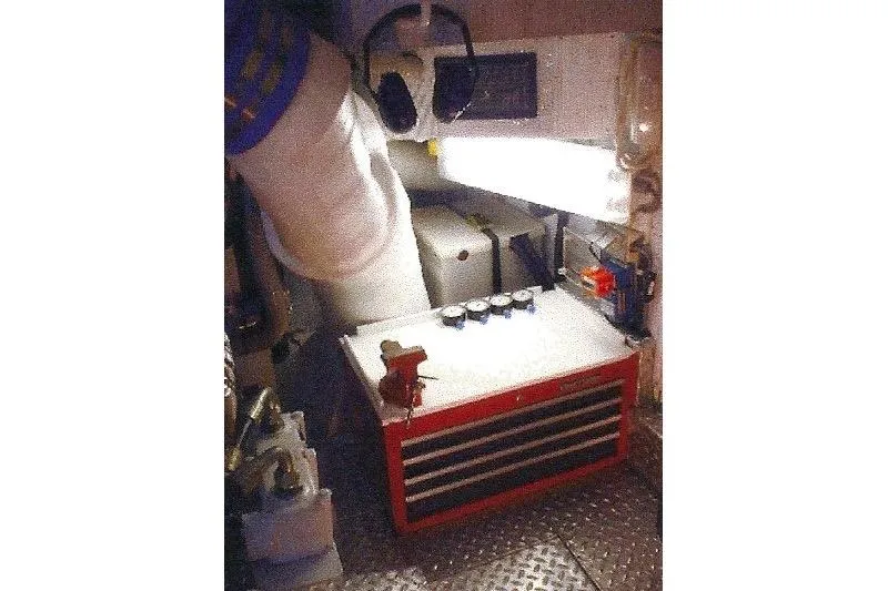 Slide: The Image of Engine room with Dyna Laguna equipment, featuring a red toolbox and safety gear. - 74