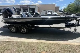 The Image of 2026 Ranger ALPHA 208 boat on trailer, parked outdoors under a clear blue sky. - 0