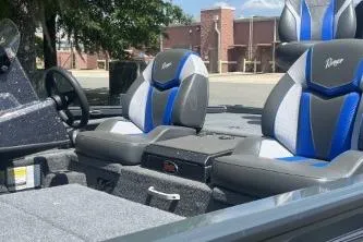 Slide: The Image of 2026 Ranger ALPHA 208 boat interior with blue and gray seating, steering wheel, and console. - 3