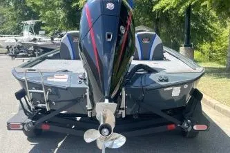 Slide: The Image of 2026 Ranger ALPHA 208 boat with powerful outboard motor, parked outdoors. - 6
