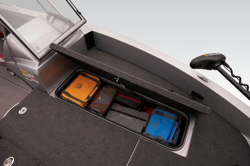 Slide: The Image of 2026 Triton 206 Allure boat interior with gray and red seating in a garage setting. - 11