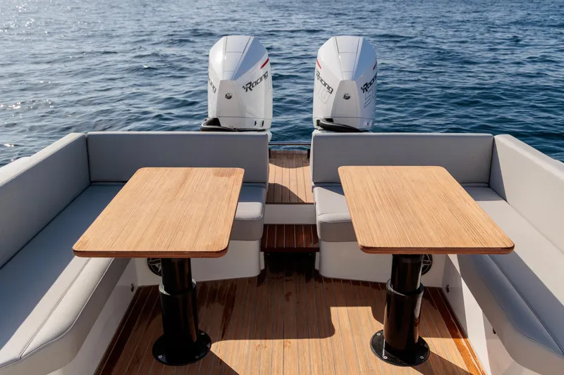 Slide: The Image of 2026 Rock Marine RM 40 boat with twin outboard engines and wooden deck tables. - 13