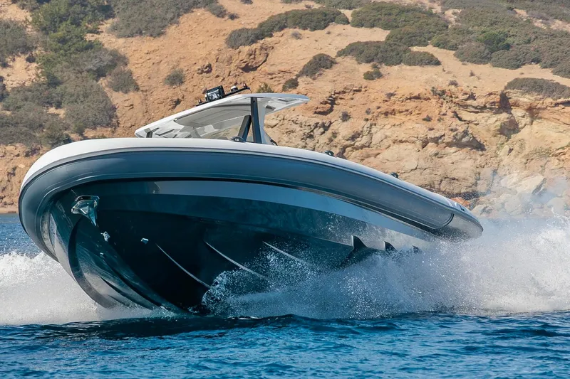 Slide: The Image of Rock Marine RM 40 boat cruising on water near rocky coastline, 2026 model. - 2