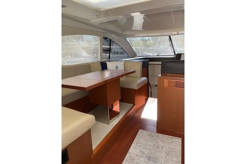 Slide: The Image of Luxurious interior of 2014 Beneteau Gran Turismo 49 yacht with elegant seating and dining area. - 10