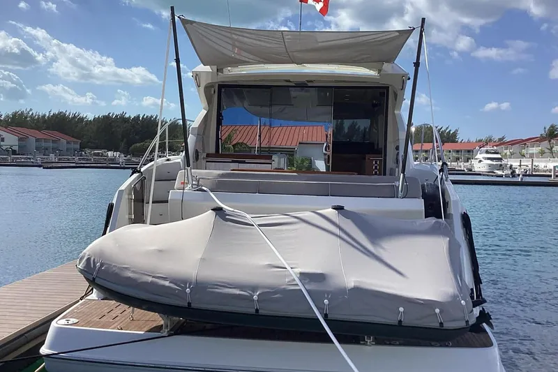 Slide: The Image of 2014 Beneteau Gran Turismo 49 yacht docked at marina under clear skies. - 2