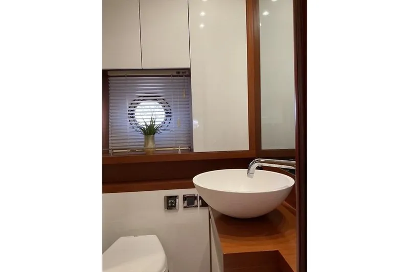 Slide: The Image of Bathroom interior of 2014 Beneteau Gran Turismo 49 yacht with modern sink and porthole window. - 23