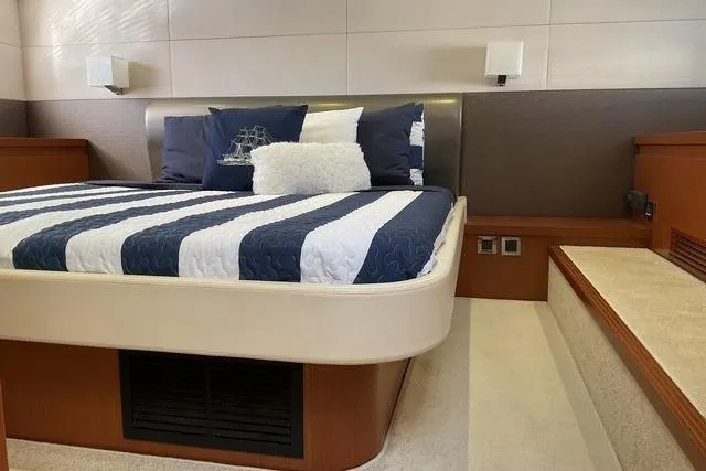 Slide: The Image of Luxurious bedroom interior of 2014 Beneteau Gran Turismo 49 yacht with striped bedding. - 24
