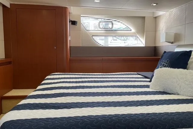 Slide: The Image of Luxurious cabin interior of 2014 Beneteau Gran Turismo 49 yacht with striped bedding. - 26
