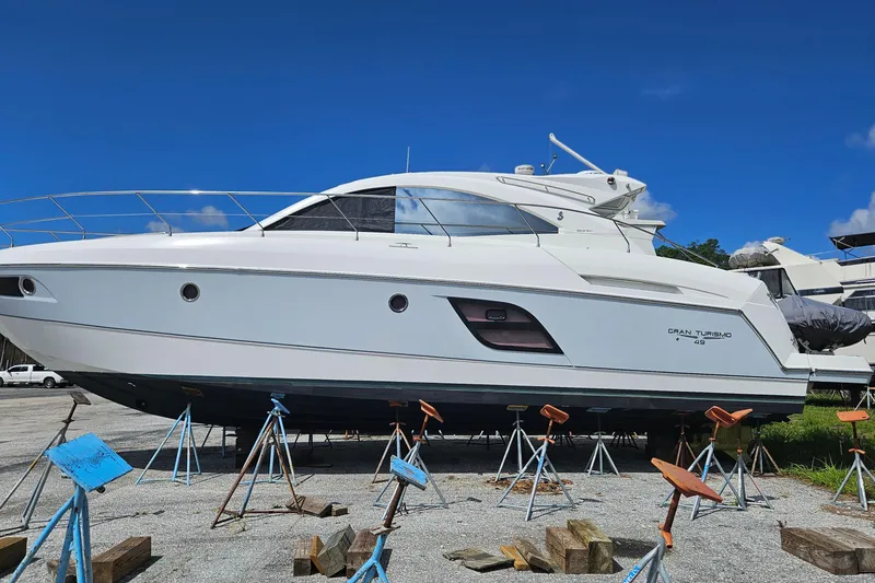 Slide: The Image of 2014 Beneteau Gran Turismo 49 yacht on stands under clear blue sky. - 33