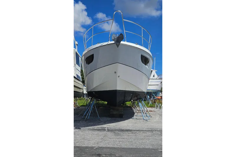 Slide: The Image of 2014 Beneteau Gran Turismo 49 yacht on dry dock under clear blue sky. - 34