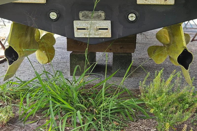 Slide: The Image of Propellers of a 2014 Beneteau Gran Turismo 49 yacht, surrounded by grass. - 35