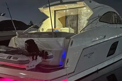 Slide: The Image of 2014 Beneteau Gran Turismo 49 yacht docked at night with illuminated interior. - 4