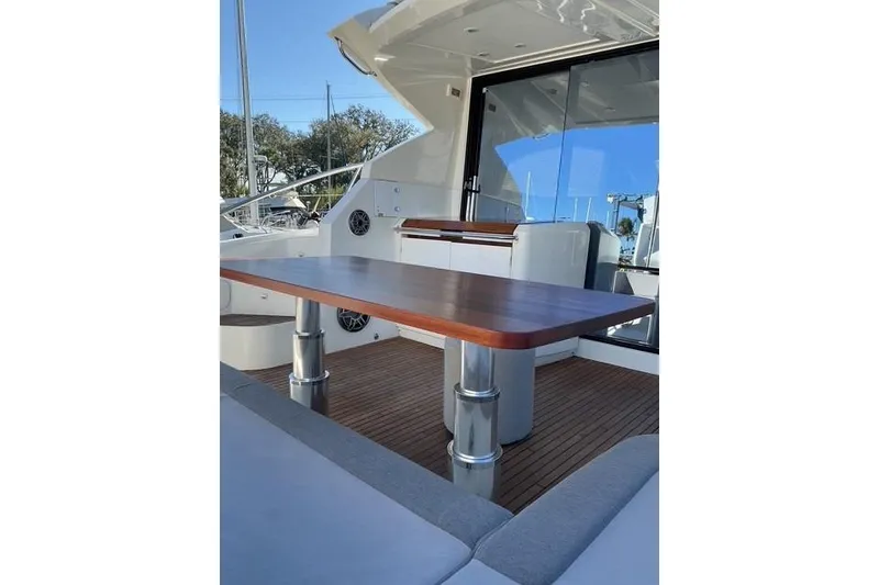 Slide: The Image of 2014 Beneteau Gran Turismo 49 yacht interior with wooden table and seating area. - 5