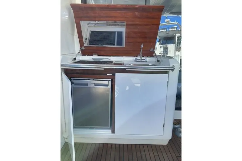 Slide: The Image of Outdoor kitchenette on 2014 Beneteau Gran Turismo 49 yacht with sink and mini fridge. - 7