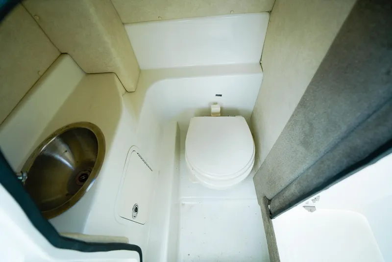 Slide: The Image of Interior of 2010 Sea Ray 270 SLX boat bathroom with toilet and sink. - 20