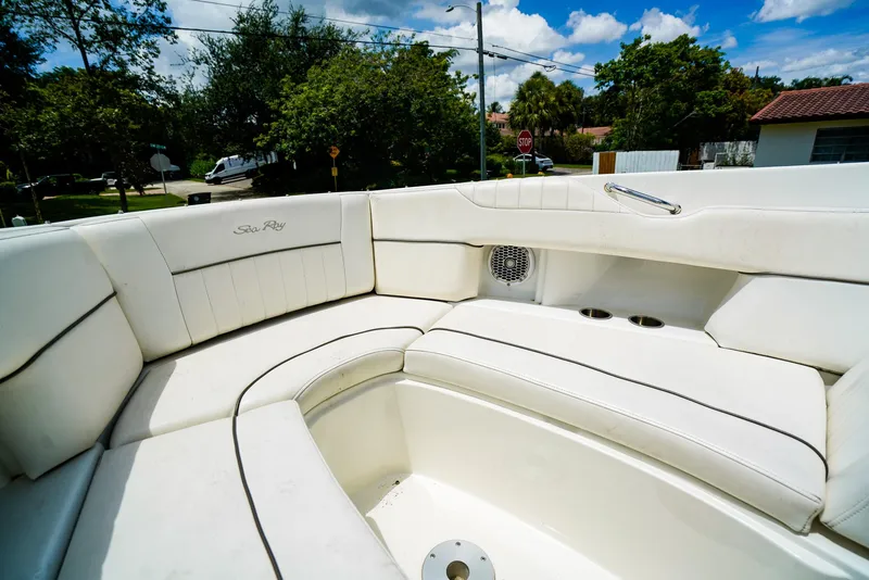 Slide: The Image of 2010 Sea Ray 270 SLX boat interior with white seating and cup holders. - 24