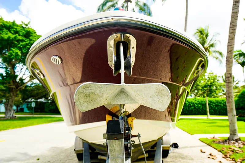 Slide: The Image of 2010 Sea Ray 270 SLX boat on trailer, surrounded by palm trees. - 28