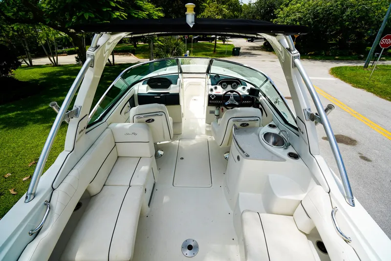 Slide: The Image of 2010 Sea Ray 270 SLX boat interior with white seating and sleek dashboard design. - 9