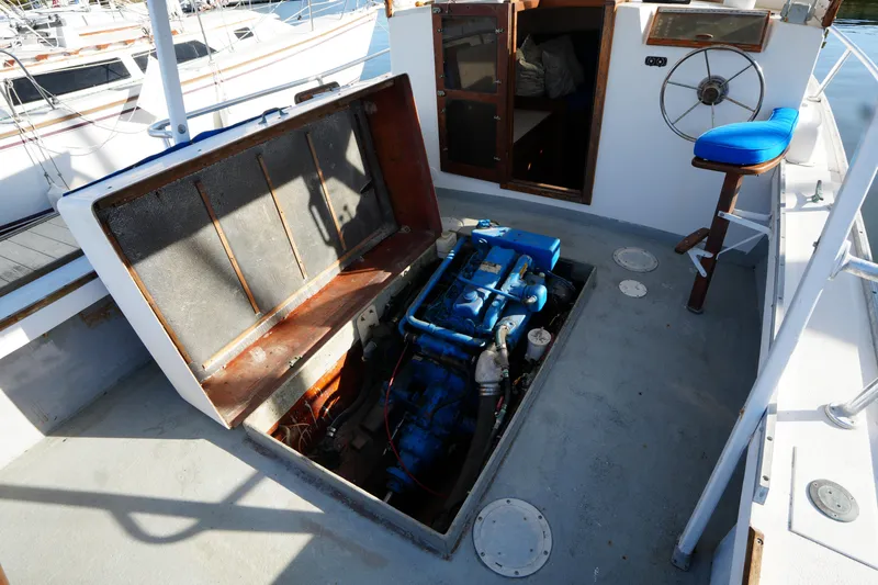 Slide: The Image of 1983 SISU 26 boat engine compartment with open hatch, showcasing blue engine and cockpit area. - 5