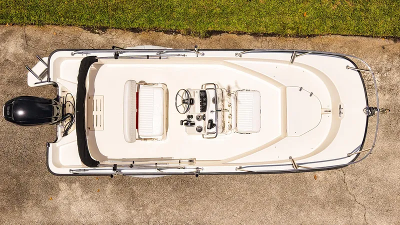 Slide: The Image of Top view of a 2016 Boston Whaler 170 Montauk boat on pavement. - 2